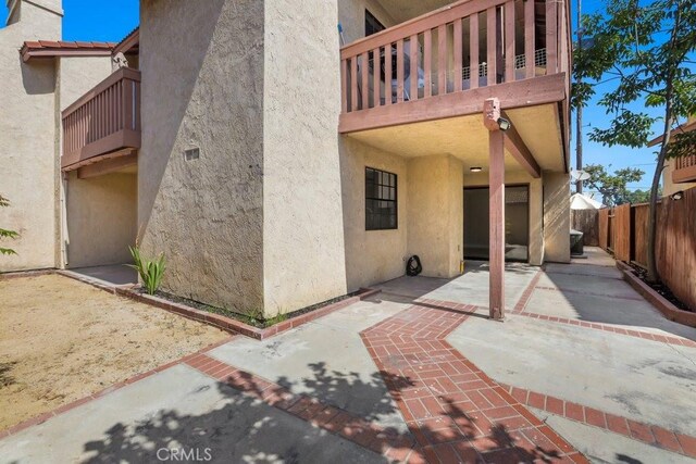 2639 Cameron Unit 119, Anaheim, CA 92801 - rear view of house with stucco siding, a balcony, and a patio