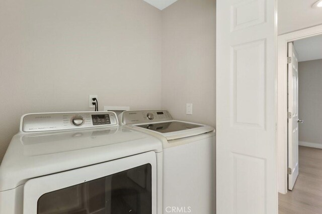 2639 Cameron Unit 119, Anaheim, CA 92801 - laundry room featuring washer and clothes dryer and light wood-type flooring