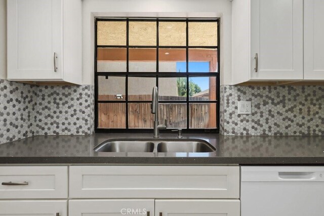 2639 Cameron Unit 119, Anaheim, CA 92801 - kitchen featuring dishwasher, white cabinetry, dark countertops, and tasteful backsplash