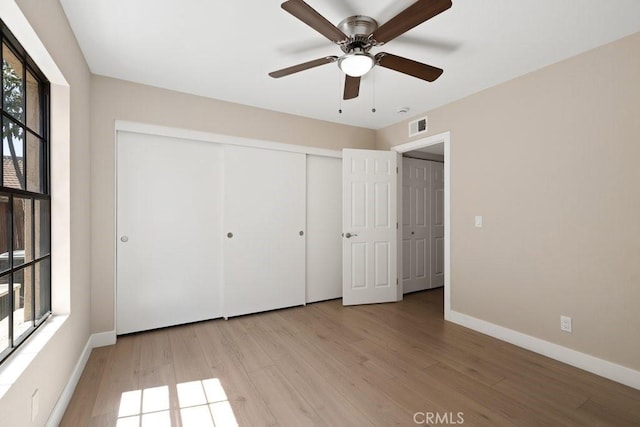 2639 Cameron Unit 119, Anaheim, CA 92801 - unfurnished bedroom with light wood-style flooring, a closet, and a ceiling fan