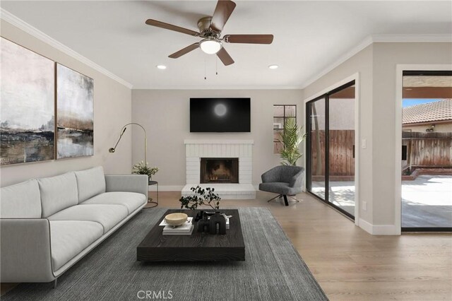 2639 Cameron Unit 119, Anaheim, CA 92801 - living area featuring a ceiling fan, wood finished floors, a fireplace, crown molding, and recessed lighting