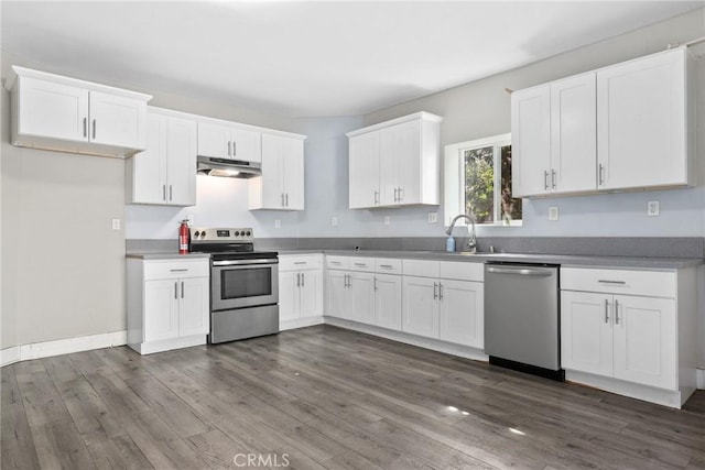 3561 E 6th St, Los Angeles, CA 90023 - kitchen featuring stainless steel appliances, under cabinet range hood, white cabinetry, and dark wood finished floors
