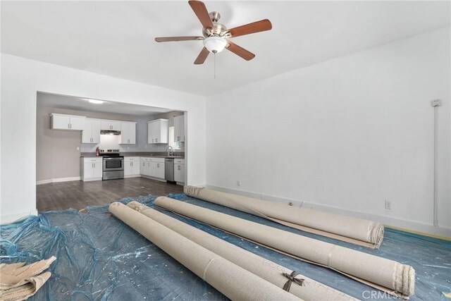 3561 E 6th St, Los Angeles, CA 90023 - unfurnished living room featuring dark wood-style flooring and a ceiling fan