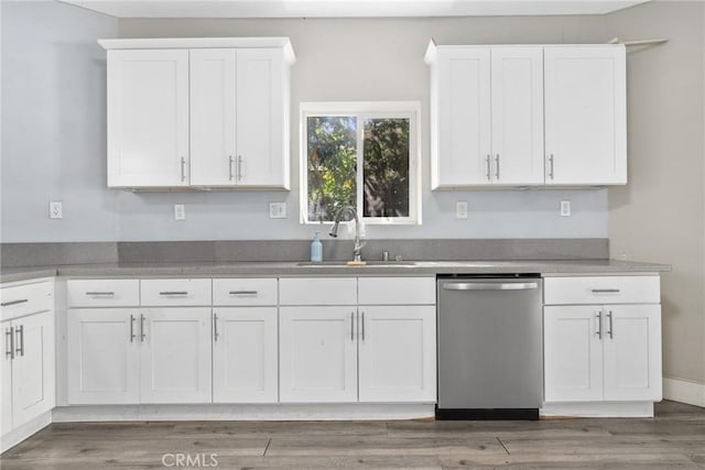3561 E 6th St, Los Angeles, CA 90023 - kitchen with stainless steel dishwasher, white cabinetry, light wood-style flooring, and light countertops