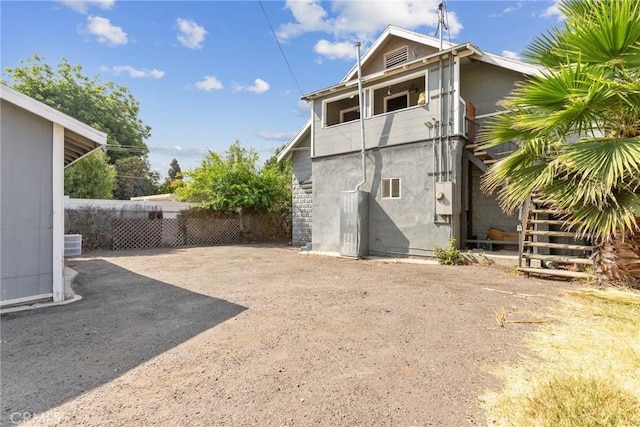 3561 E 6th St, Los Angeles, CA 90023 - rear view of house featuring stairs, a balcony, and stucco siding