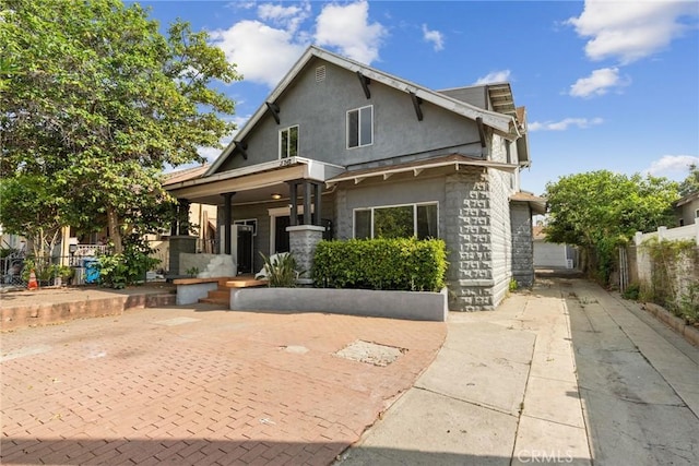 3561 E 6th St, Los Angeles, CA 90023 - view of front of home featuring stone siding and covered porch