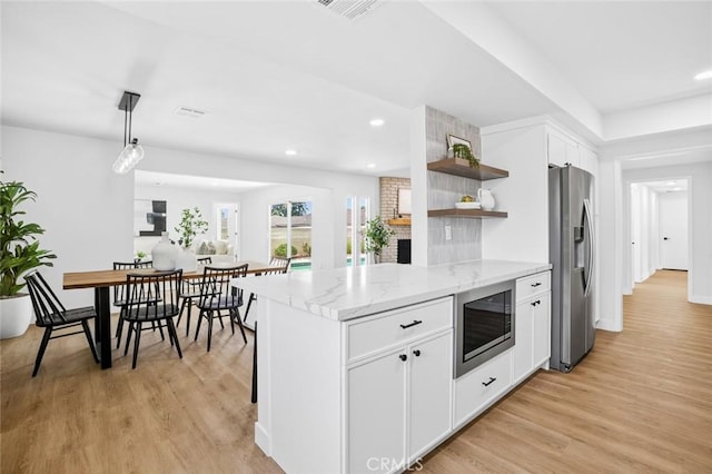 413 N Rimhurst Ave, Covina, CA 91724 - kitchen featuring stainless steel refrigerator with ice dispenser, built in microwave, open shelves, white cabinetry, and light wood-style floors