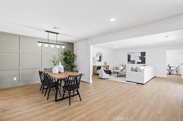 413 N Rimhurst Ave, Covina, CA 91724 - dining room featuring light wood-type flooring, recessed lighting, and a decorative wall