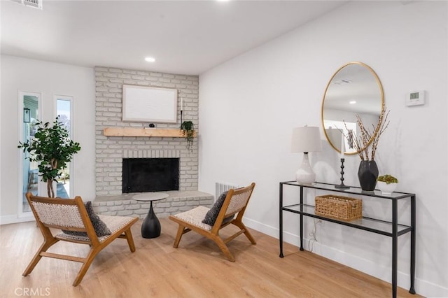 413 N Rimhurst Ave, Covina, CA 91724 - sitting room featuring wood finished floors, a brick fireplace, and recessed lighting