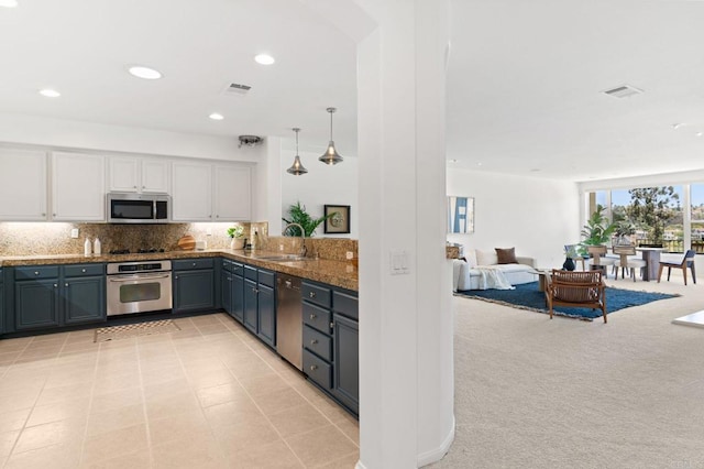 2534 Navarra Dr Unit C, Carlsbad, CA 92009 - kitchen featuring stainless steel appliances, white cabinetry, decorative backsplash, open floor plan, and recessed lighting