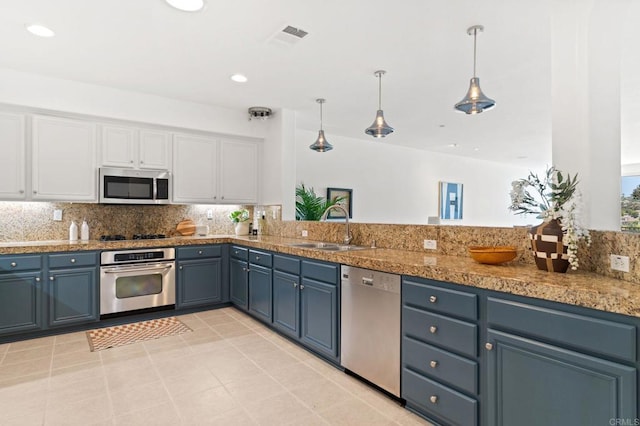 2534 Navarra Dr Unit C, Carlsbad, CA 92009 - kitchen with stainless steel appliances, white cabinets, decorative backsplash, blue cabinetry, and recessed lighting