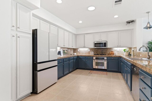 2534 Navarra Dr Unit C, Carlsbad, CA 92009 - kitchen featuring stainless steel appliances, blue cabinetry, white cabinetry, and recessed lighting