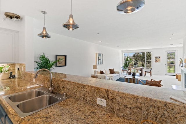 2534 Navarra Dr Unit C, Carlsbad, CA 92009 - kitchen with tile counters, white cabinetry, hanging light fixtures, and open floor plan