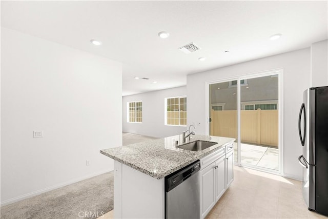 16017 Tanzinite Ln, Chino, CA 91708 - kitchen with stainless steel appliances, light stone counters, a kitchen island with sink, white cabinets, and recessed lighting