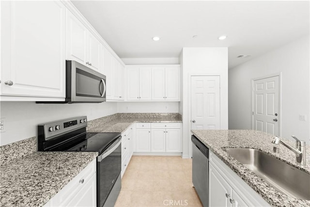 16017 Tanzinite Ln, Chino, CA 91708 - kitchen featuring stainless steel appliances, white cabinets, light stone counters, and recessed lighting