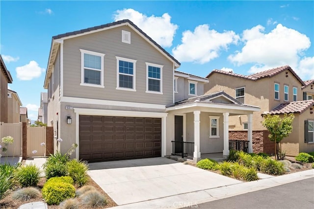16017 Tanzinite Ln, Chino, CA 91708 - traditional home featuring a garage, concrete driveway, stucco siding, and covered porch