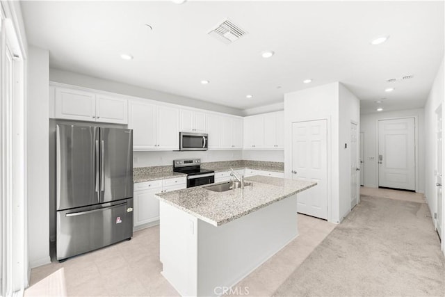 16017 Tanzinite Ln, Chino, CA 91708 - kitchen with stainless steel appliances, white cabinetry, a kitchen island with sink, recessed lighting, and light stone countertops