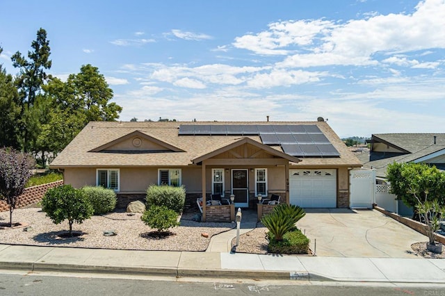 1926 Pamela Ln, Escondido, CA 92026 - view of front facade with stucco siding, an attached garage, driveway, solar panels, and stone siding