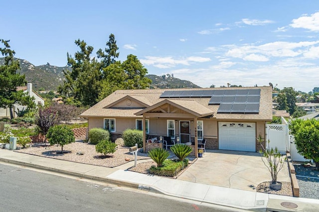 1926 Pamela Ln, Escondido, CA 92026 - view of front facade featuring covered porch, an attached garage, stucco siding, roof mounted solar panels, and stone siding