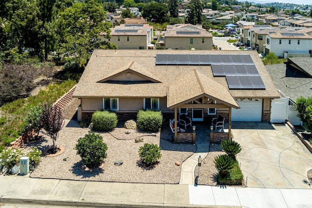 1926 Pamela Ln, Escondido, CA 92026 - view of front of home with roof with shingles, concrete driveway, roof mounted solar panels, and stone siding