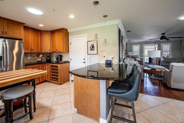 1926 Pamela Ln, Escondido, CA 92026 - kitchen with a kitchen breakfast bar, light tile patterned floors, brown cabinets, a peninsula, and backsplash