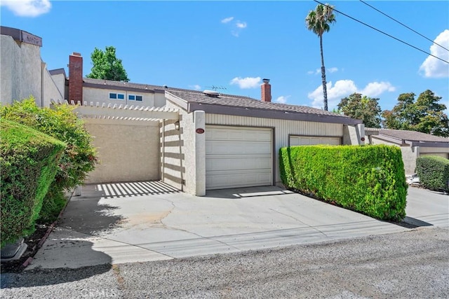 823 Daffodil, Riverside, CA 92507 - view of front facade featuring an attached garage, concrete driveway, and a chimney