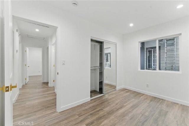 5171 S Wilton Pl, Los Angeles, CA 90062 - unfurnished bedroom featuring light wood finished floors, attic access, recessed lighting, and a closet