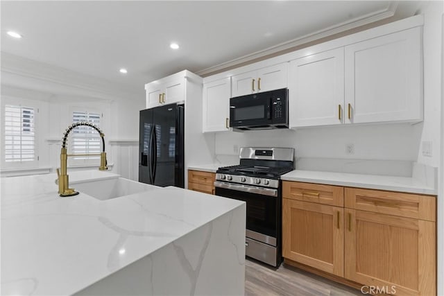 5171 S Wilton Pl, Los Angeles, CA 90062 - kitchen featuring black appliances, ornamental molding, light stone countertops, recessed lighting, and light wood-style floors