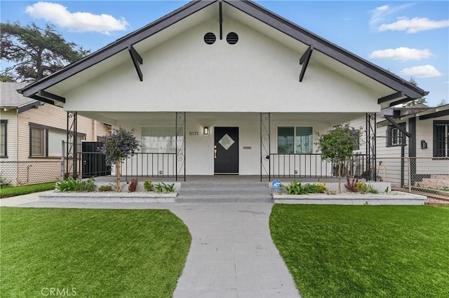 5171 S Wilton Pl, Los Angeles, CA 90062 - view of front of home with covered porch, a front yard, and stucco siding
