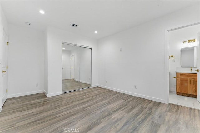 5171 S Wilton Pl, Los Angeles, CA 90062 - unfurnished bedroom with light wood-style floors, a closet, recessed lighting, and ensuite bathroom