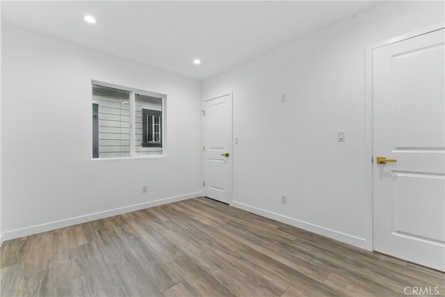 5171 S Wilton Pl, Los Angeles, CA 90062 - unfurnished room with wood finished floors and recessed lighting