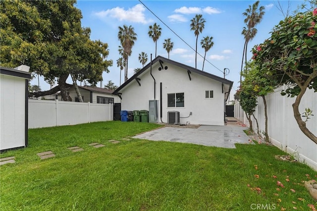5171 S Wilton Pl, Los Angeles, CA 90062 - rear view of house with a fenced backyard, a patio, and stucco siding