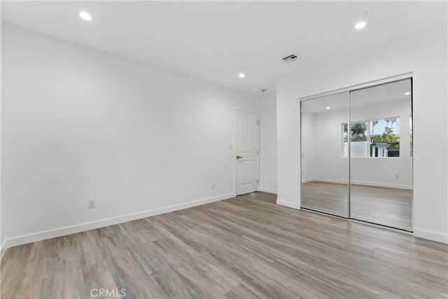 5171 S Wilton Pl, Los Angeles, CA 90062 - unfurnished bedroom with wood finished floors, recessed lighting, and a closet