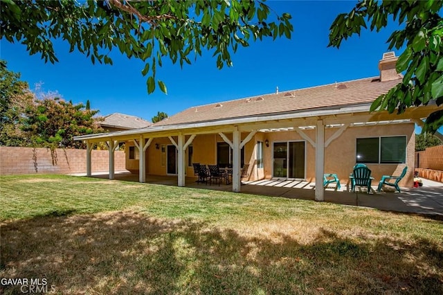 4018 Via Barbara, Lancaster, CA 93536 - back of house with stucco siding, a patio, and a chimney