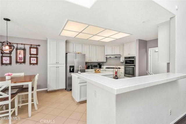 4018 Via Barbara, Lancaster, CA 93536 - kitchen featuring appliances with stainless steel finishes, light tile patterned floors, white cabinets, a peninsula, and decorative light fixtures