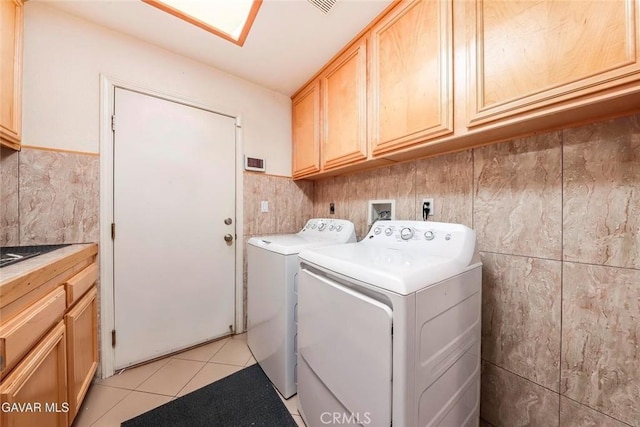 4018 Via Barbara, Lancaster, CA 93536 - laundry area with washing machine and clothes dryer, cabinet space, tile walls, and light tile patterned flooring