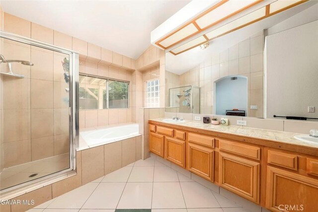 4018 Via Barbara, Lancaster, CA 93536 - bathroom with a shower stall, double vanity, a garden tub, tile patterned flooring, and tile walls