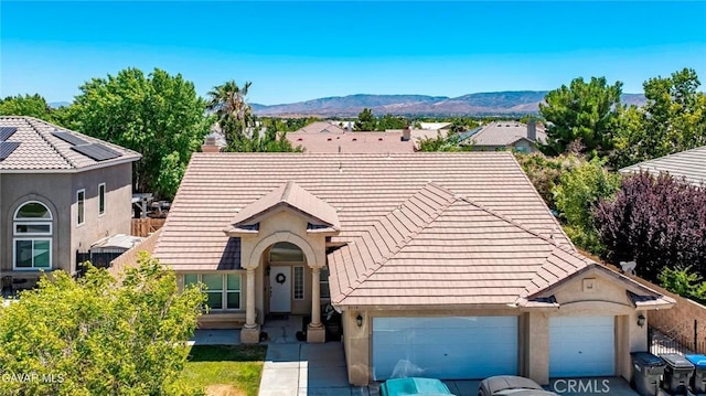 4018 Via Barbara, Lancaster, CA 93536 - view of front of home with an attached garage, driveway, a mountain view, stucco siding, and a tile roof