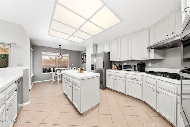 4018 Via Barbara, Lancaster, CA 93536 - kitchen featuring stainless steel appliances, white cabinetry, light countertops, and light tile patterned floors