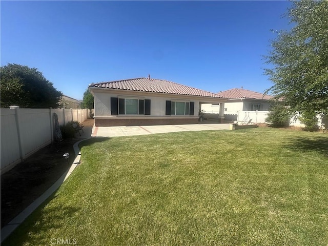 1185 Lantana Rd, Beaumont, CA 92223 - back of house with stucco siding, a tile roof, a patio area, and a fenced backyard