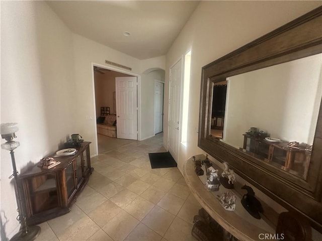 1185 Lantana Rd, Beaumont, CA 92223 - hallway featuring arched walkways and light tile patterned flooring
