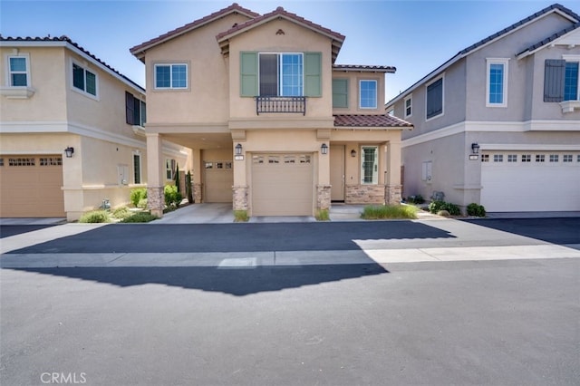 15147 Ridge Ln Unit 5, Fontana, CA 92336 - view of front of house with a tiled roof, a garage, stucco siding, and stone siding