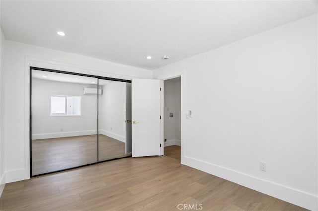 17043 Celtic St, Granada Hills, CA 91344 - unfurnished bedroom with a wall unit AC, light wood finished floors, recessed lighting, and a closet