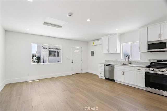 17043 Celtic St, Granada Hills, CA 91344 - kitchen featuring appliances with stainless steel finishes, light countertops, healthy amount of natural light, white cabinetry, and recessed lighting