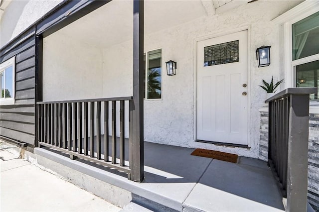 17043 Celtic St, Granada Hills, CA 91344 - doorway to property with covered porch and stucco siding