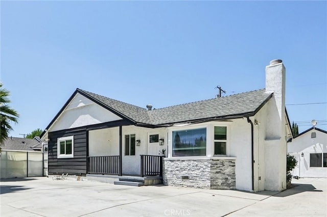 17043 Celtic St, Granada Hills, CA 91344 - view of front facade with a chimney, stucco siding, and roof with shingles