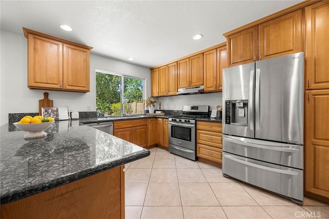 4161 E Fauna Ave, Anaheim, CA 92807 - kitchen featuring appliances with stainless steel finishes, under cabinet range hood, brown cabinets, recessed lighting, and light tile patterned floors