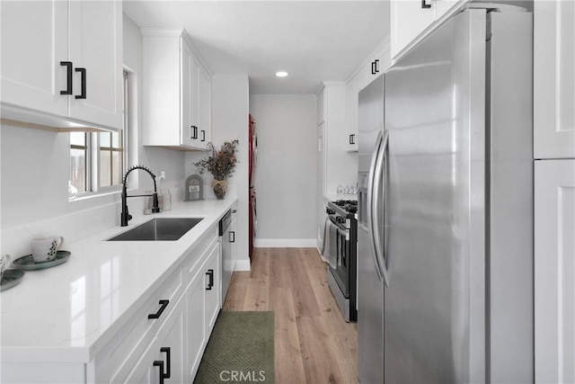21815 Jelan Ave, Apple Valley, CA 92307 - kitchen featuring stainless steel appliances, white cabinets, light wood-style flooring, and recessed lighting