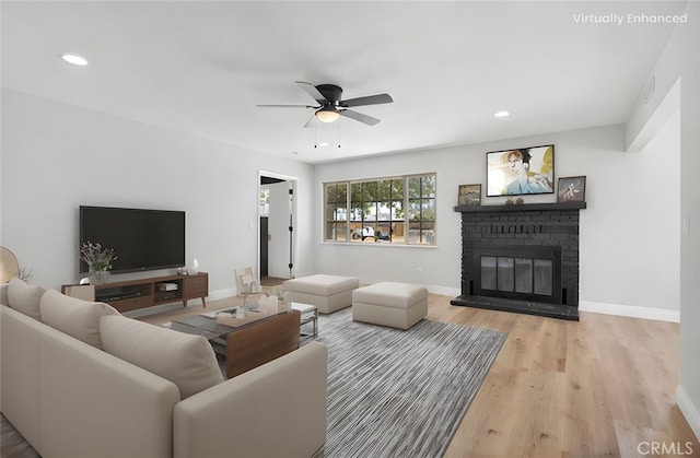 21815 Jelan Ave, Apple Valley, CA 92307 - living room featuring ceiling fan, a fireplace, light wood-style flooring, and recessed lighting