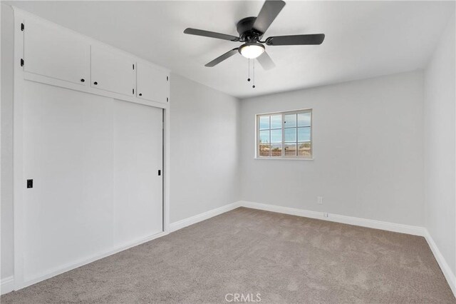 21815 Jelan Ave, Apple Valley, CA 92307 - unfurnished bedroom with carpet flooring, a closet, and a ceiling fan